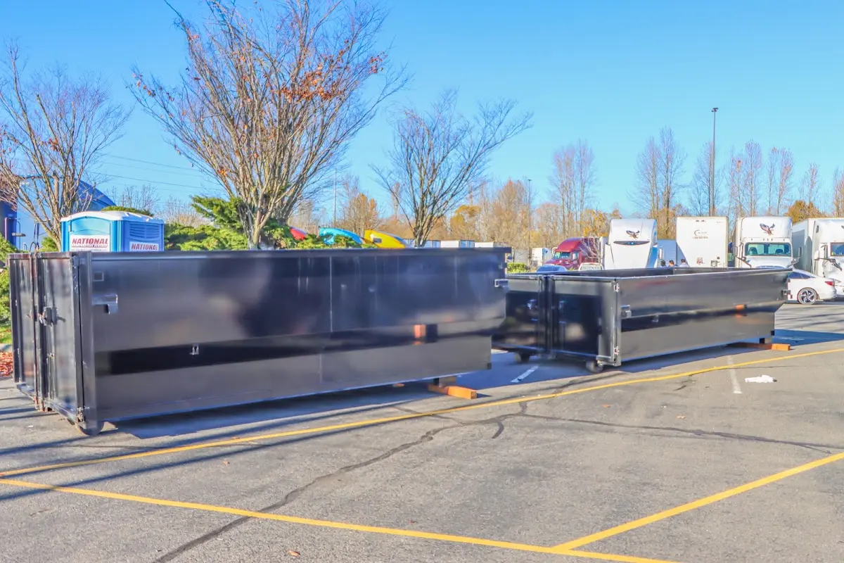 Professional dumpster rental service with roll-off container on residential driveway in Valley Center